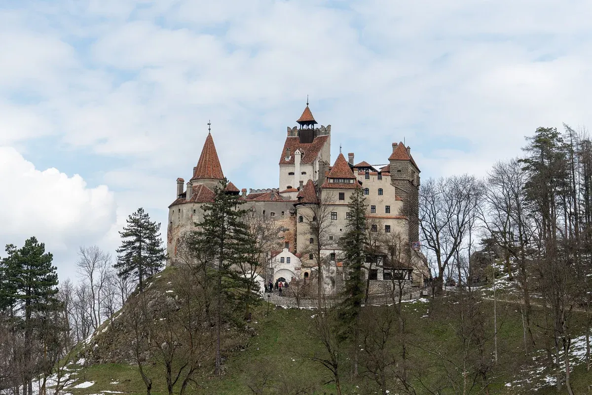 Bran Castle above the trees in spring, the castle at the centre of Dracula Castle tours