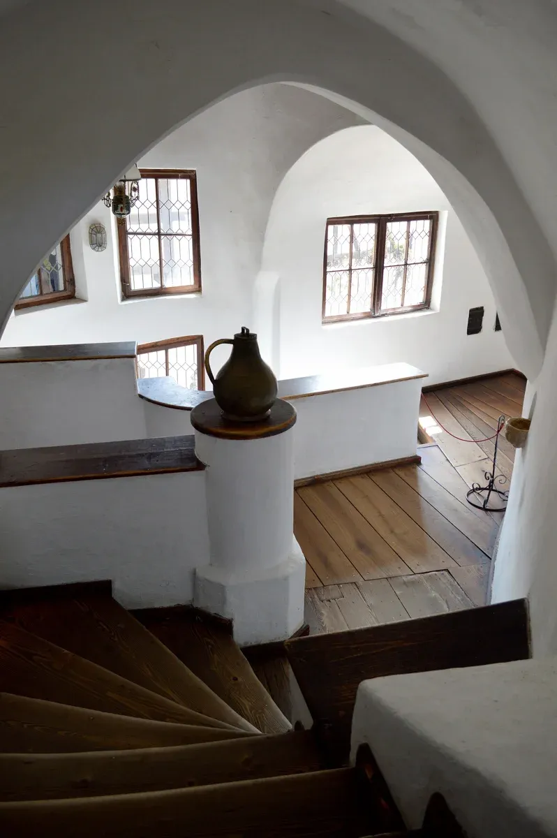 A whitewashed staircase and corridor inside Bran Castle on a standard Bran Castle ticket